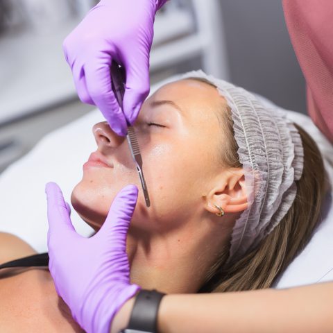 Patient receiving dermaplaning treatment